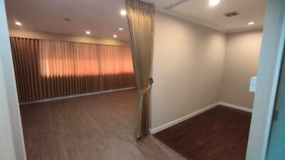 empty room with curtain, wooden floor and recessed lighting