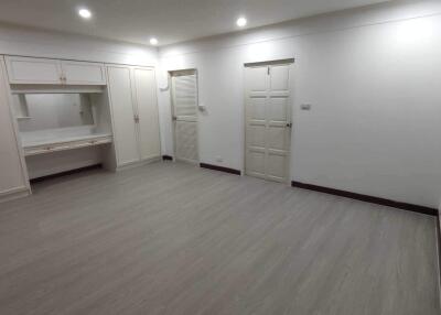 Spacious bedroom with built-in wardrobes and a dressing area