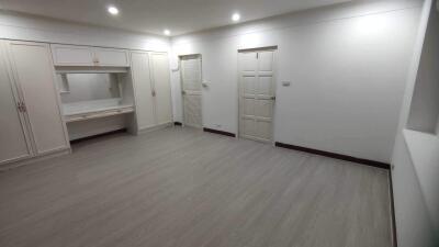 Spacious bedroom with built-in wardrobes and a dressing area