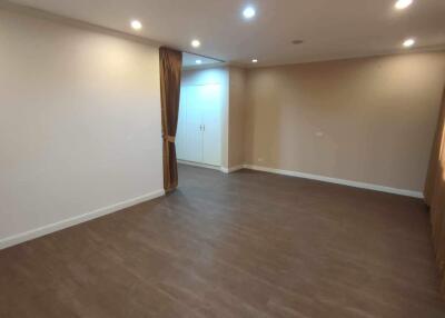 Spacious living room with laminate flooring and recessed lighting