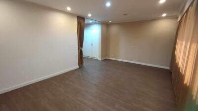 Spacious living room with laminate flooring and recessed lighting