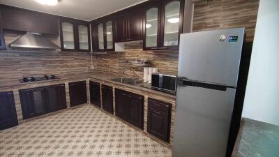 Modern kitchen with wooden cabinets and stainless steel appliances