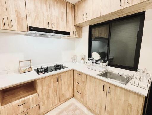 Modern kitchen with wooden cabinets and stainless steel sink