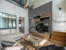 Modern living room with a high ceiling, hardwood floors, and contemporary furnishings