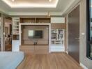 Modern living room with wooden floor, TV unit and bookshelves