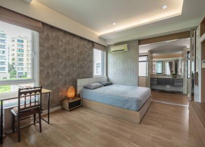 spacious bedroom with a king-sized bed and modern decor