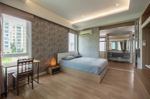 spacious bedroom with a king-sized bed and modern decor