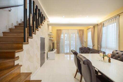 Modern living and dining area with staircase