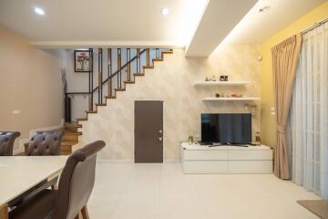 Modern living room with TV and staircase