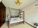 Bedroom with a four-poster bed and wooden built-in wardrobe