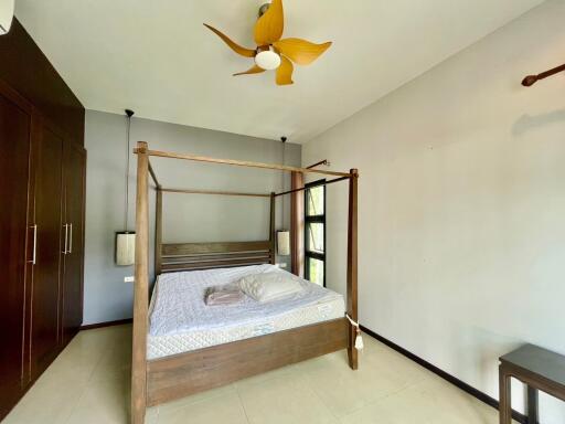 Bedroom with a four-poster bed and wooden built-in wardrobe