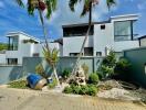 Modern building exterior with garden and palm trees