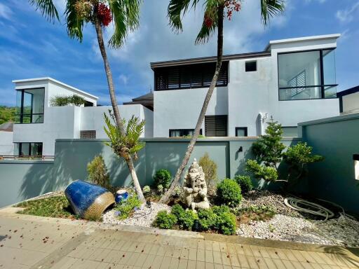 Modern building exterior with garden and palm trees