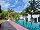 outdoor pool area with trees and modern buildings