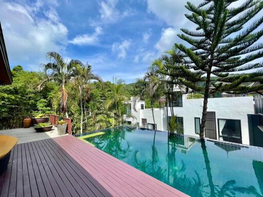 outdoor pool area with trees and modern buildings