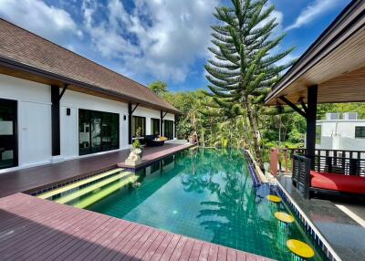 Outdoor swimming pool area with wooden deck and scenic view