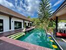 Outdoor swimming pool area with wooden deck and scenic view