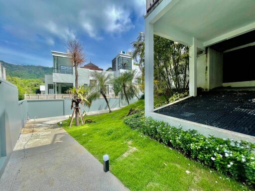 Modern residential building with driveway and landscaped garden