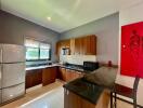 modern kitchen with wood cabinetry and bar seating