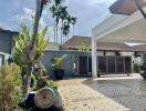 Modern house exterior with driveway and palm trees