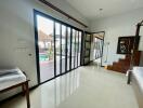 Spacious bedroom with sliding glass doors leading to a patio and pool