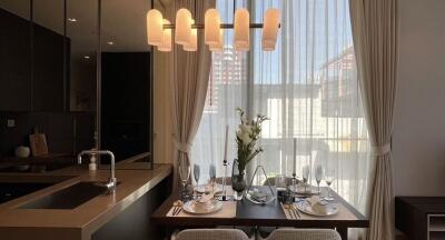 Dining area with a table set for four under modern lighting