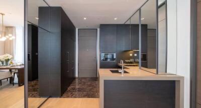 Modern kitchen with dark cabinets and built-in appliances