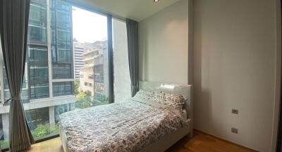 Modern bedroom with large windows and city view