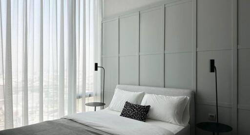 Modern bedroom with minimalist decor and large windows