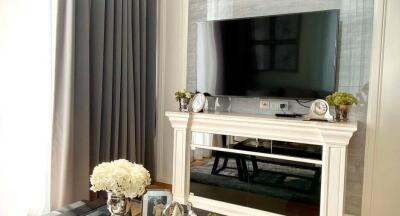 Elegantly decorated living room with a TV and fireplace