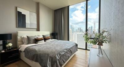 Modern bedroom with a large window view of the city