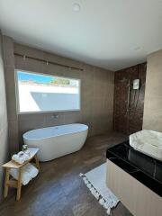 Modern bathroom with a bathtub, shower area, and sink