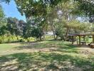 Spacious backyard garden with trees and open area