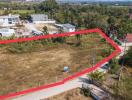 Aerial view of a vacant land plot surrounded by a red border