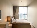 Modern bedroom with large window and city view