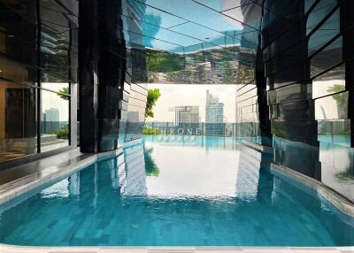 Luxurious indoor swimming pool area with city views