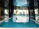 Luxurious indoor swimming pool area with city views