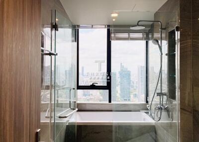 Modern bathroom with large window and city view