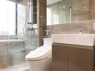 Modern bathroom with glass shower and white fixtures