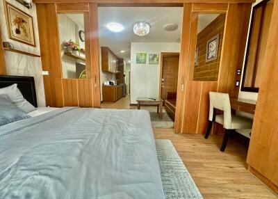 Spacious bedroom with wooden accents and an adjoining reading nook