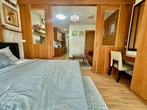 Spacious bedroom with wooden accents and an adjoining reading nook