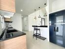 Modern kitchen with black countertops, a breakfast bar, and stainless steel appliances