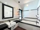 Modern bathroom with bathtub, mirror, and sink