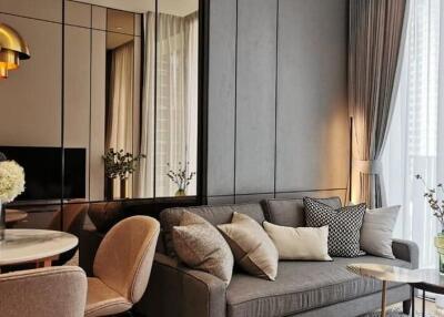 Modern living room with gray sofa and mirrored wall