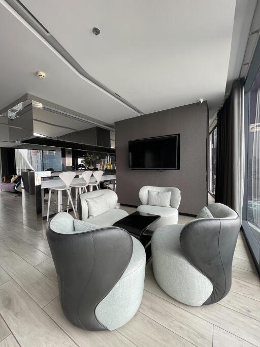 Modern living area with contemporary furniture and open kitchen