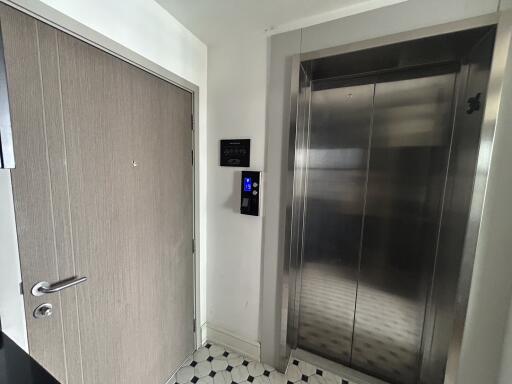 Elevator area with adjacent door