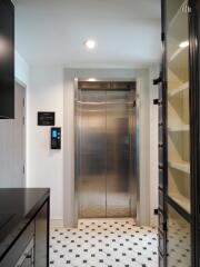 Elevator entrance with shelving and keypad