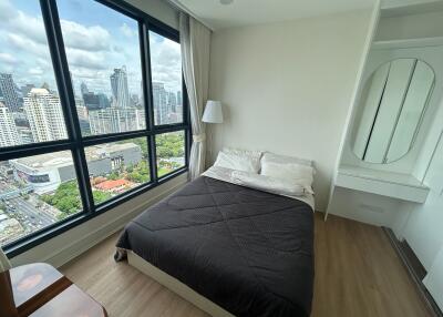 Bedroom with a large window offering city views