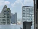 View of infinity pool with cityscape background