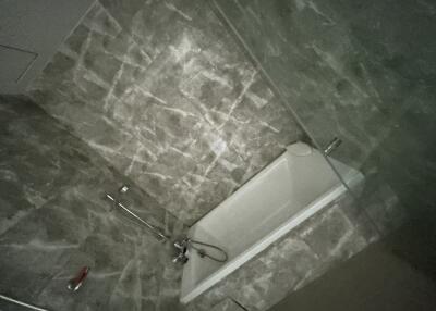 Bathroom with modern marble tiling and bathtub